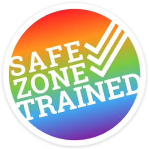 Circle graphic with soft rainbow background. Text in all caps white bold: "Safe Zone Trained" with 3 check marks on top of each other.